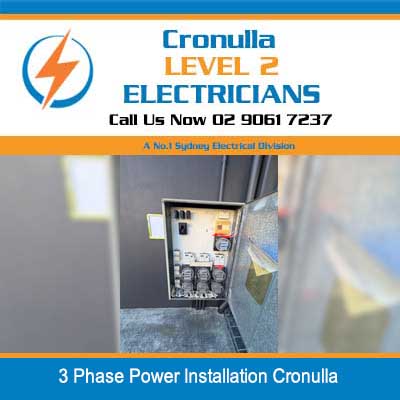 Electrician installing wiring in open 3 phase power electrical panel box in Cronulla